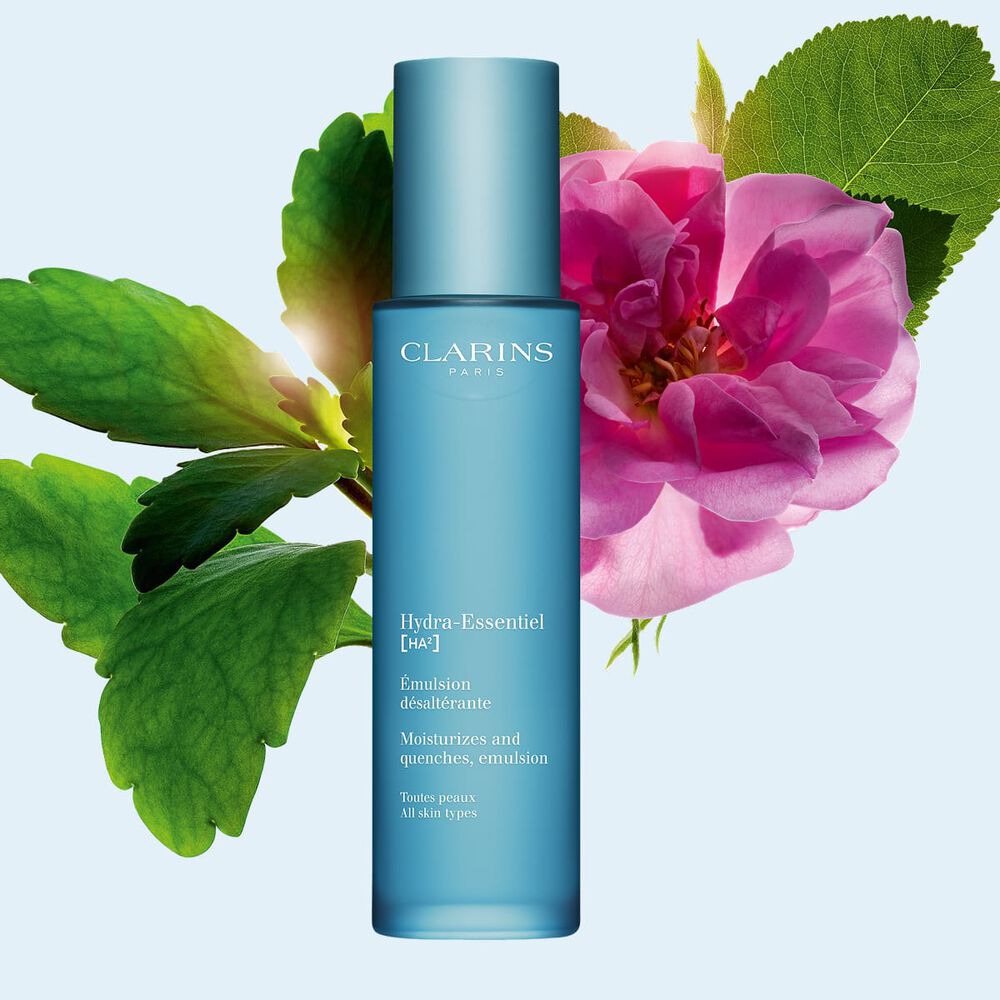 Kuva Clarins Hydra-Essentiel 23 Emulsion emulsiovoiteesta, damaskinruususta ja sulkaitulehden lehdest&auml; sinist&auml; taustaa vasten.